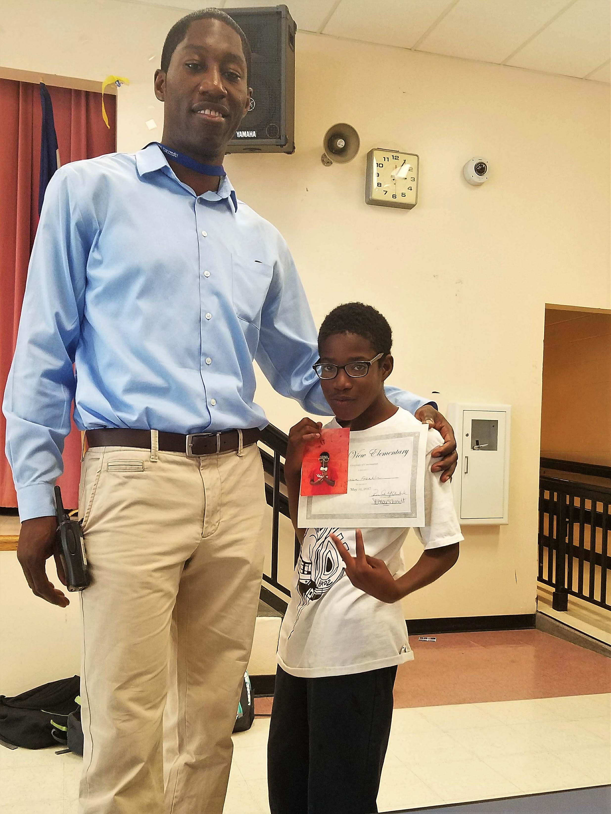 Terrence standing with student
