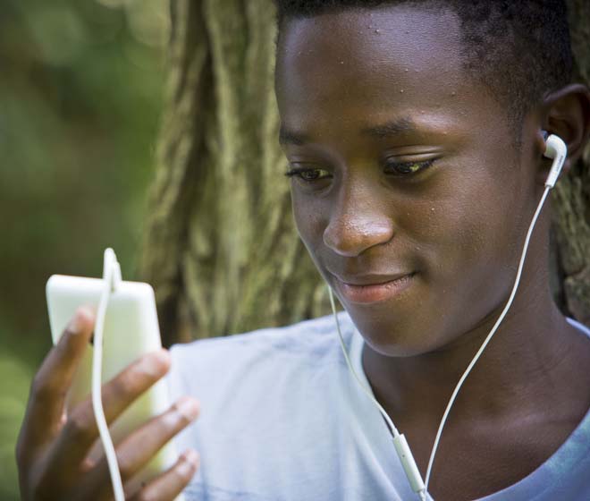Middle School boy with looking at iPod