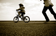 child ridding on a bike without training wheels
