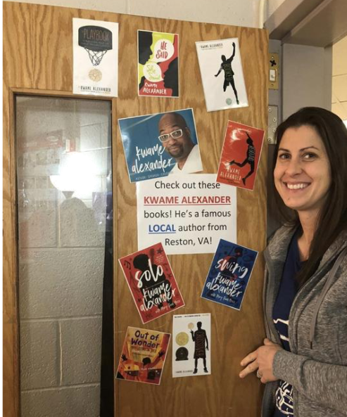 Virginia Teacher Katherine York standing at her classroom door with pictures of author Kwame Alexander.