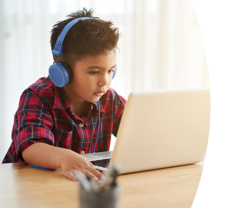 Kid with headphones on laptop