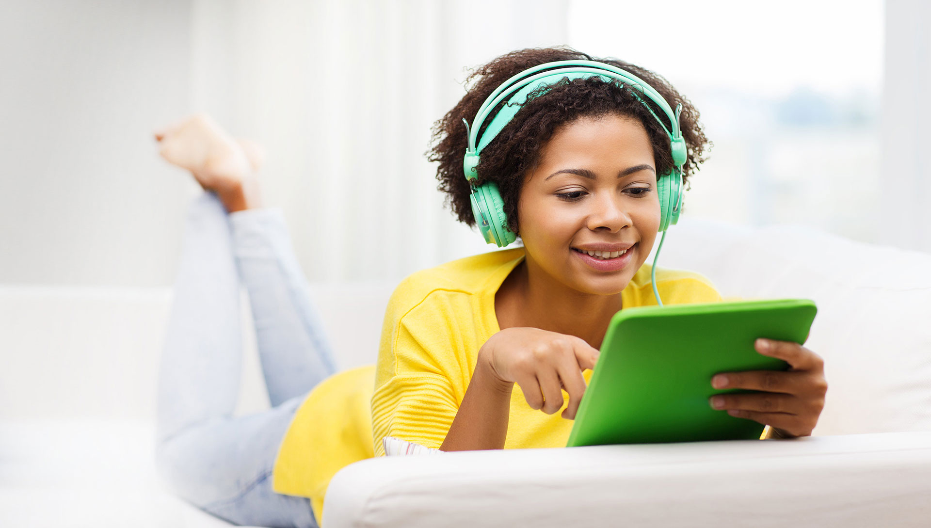 young girl smiling and listening to audiobooks