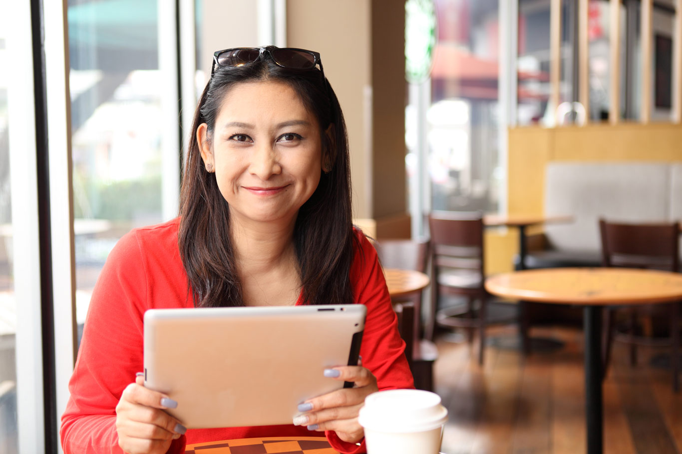 woman-in-red-shirt-holding-ipad