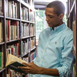 photo of a student reading in the library
